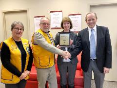 The Lions Club present Russ & Sharon Culver with plaque to recognize their support throughout the Christmas season.